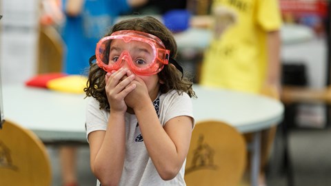 Girl with diving goggles on looking surprised 
