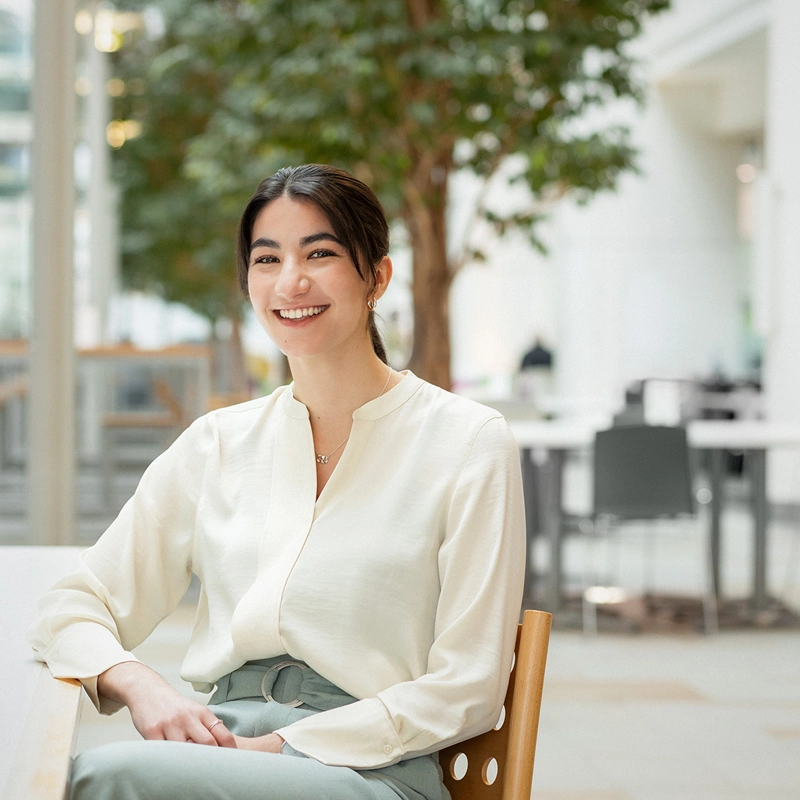 female employee in atrium of a building.