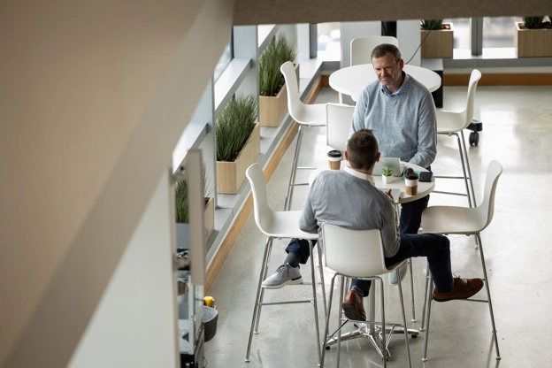 Two employees discussing work in the office cafe