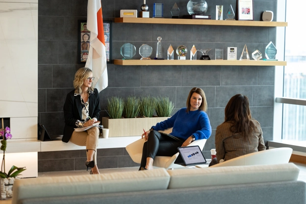 A group of employees discussing work in the office