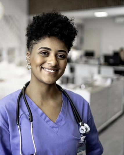 Healthcare professional in hospital setting smiling at camera