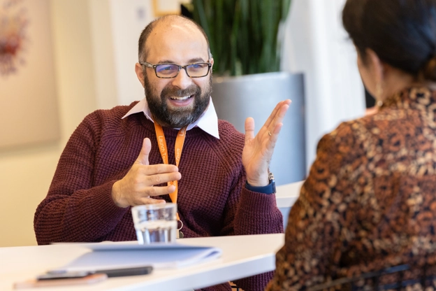 A man talking to a woman in the office