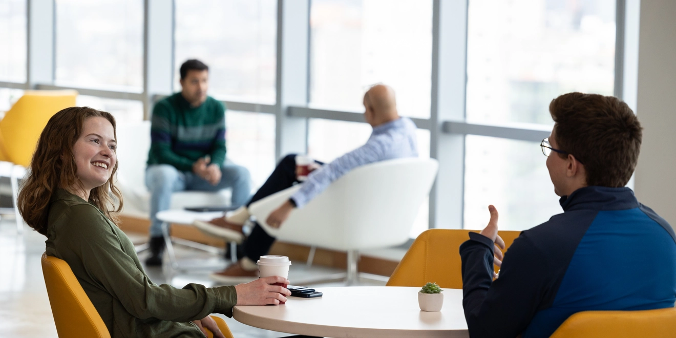 Two employees talking in the office cafe