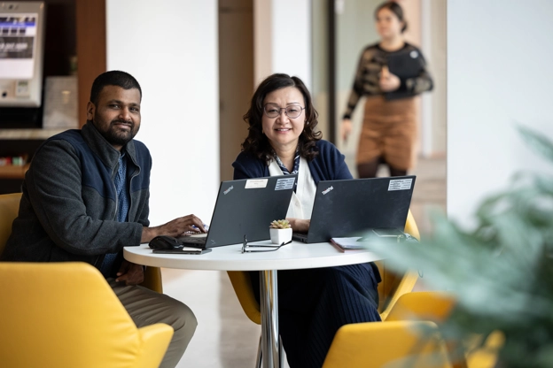 Two office employees smiling